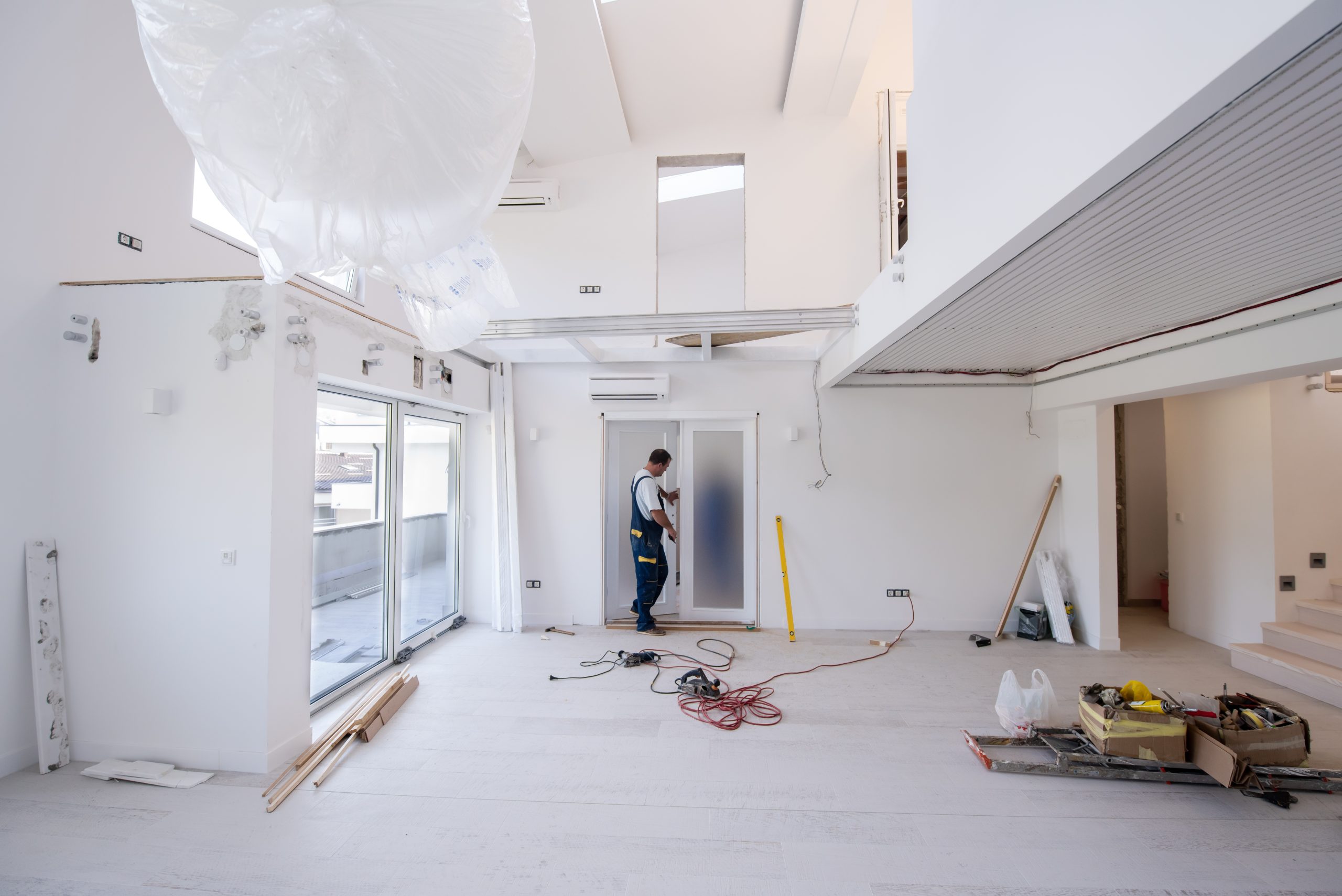 Worker installing a door during home renovations